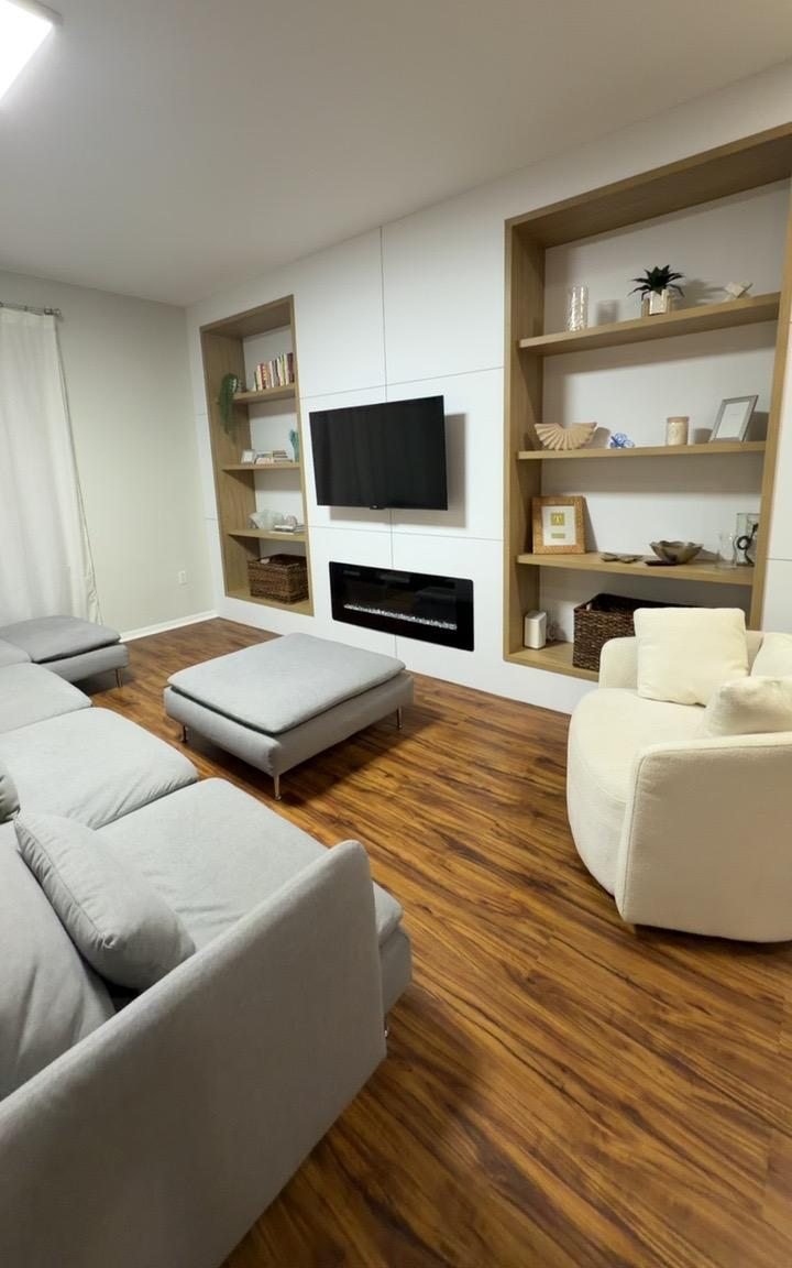 Living room with built-in shelves and a tidy sofa